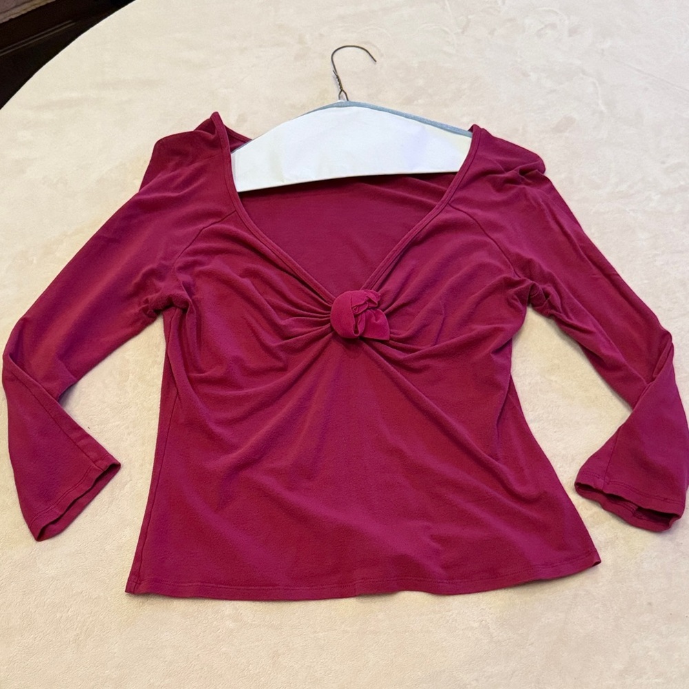 Women’s magenta blouse with rose detail at bust